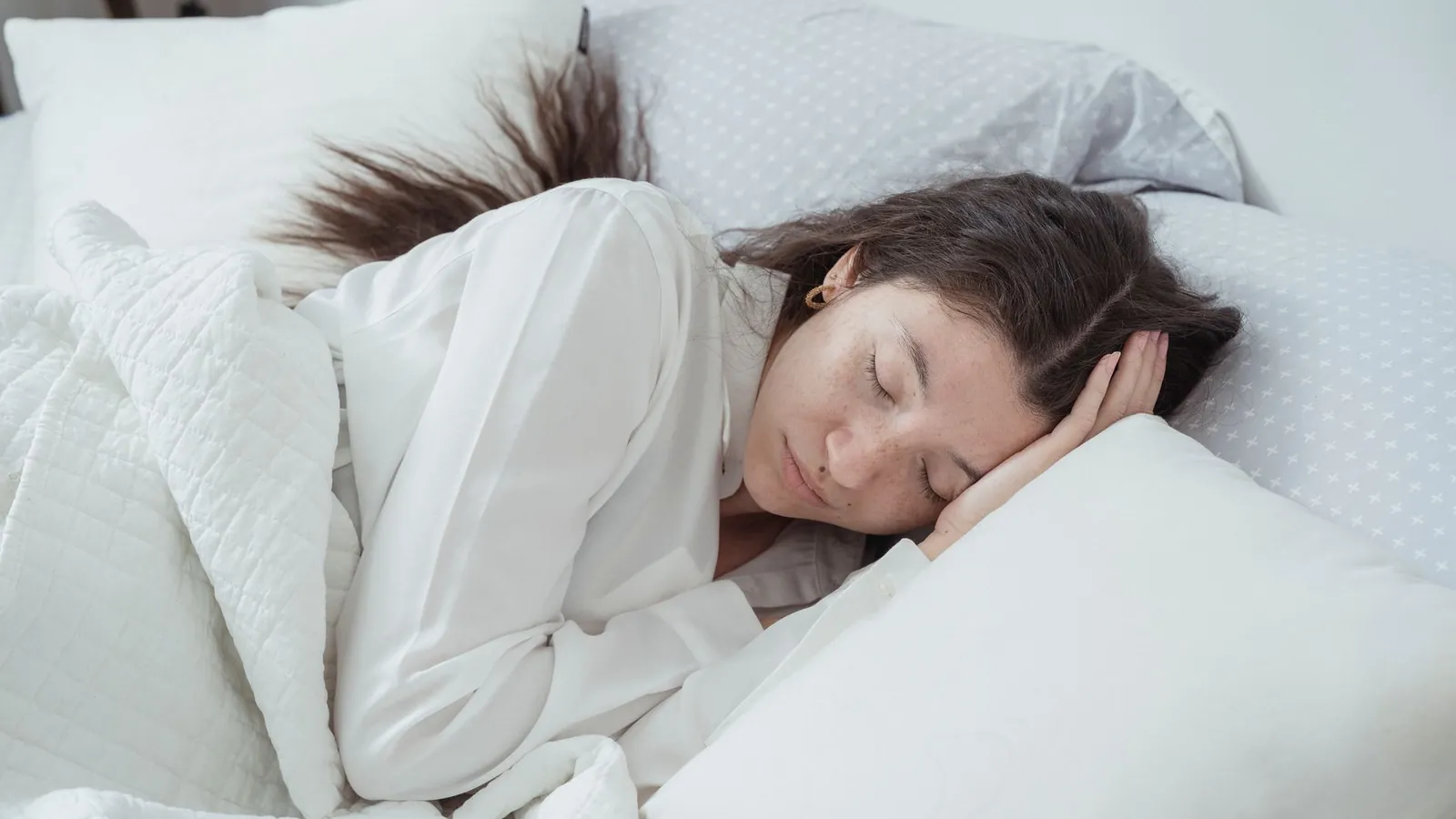 A woman sleeping on her side on a supportive pillow