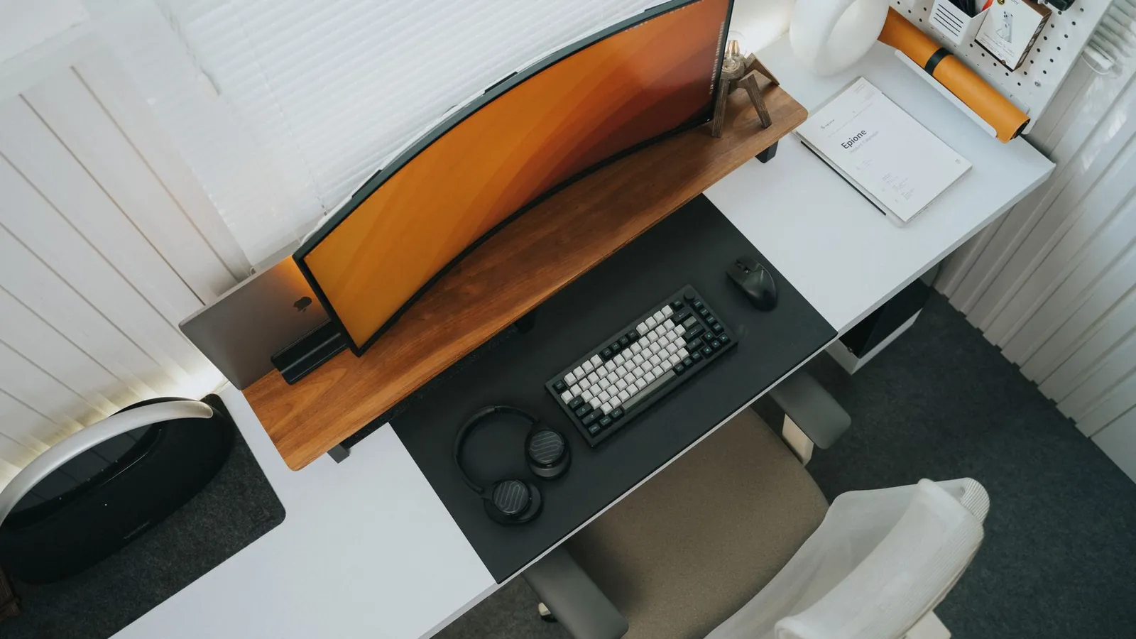 A bright desk setup with the monitor raised to eye level