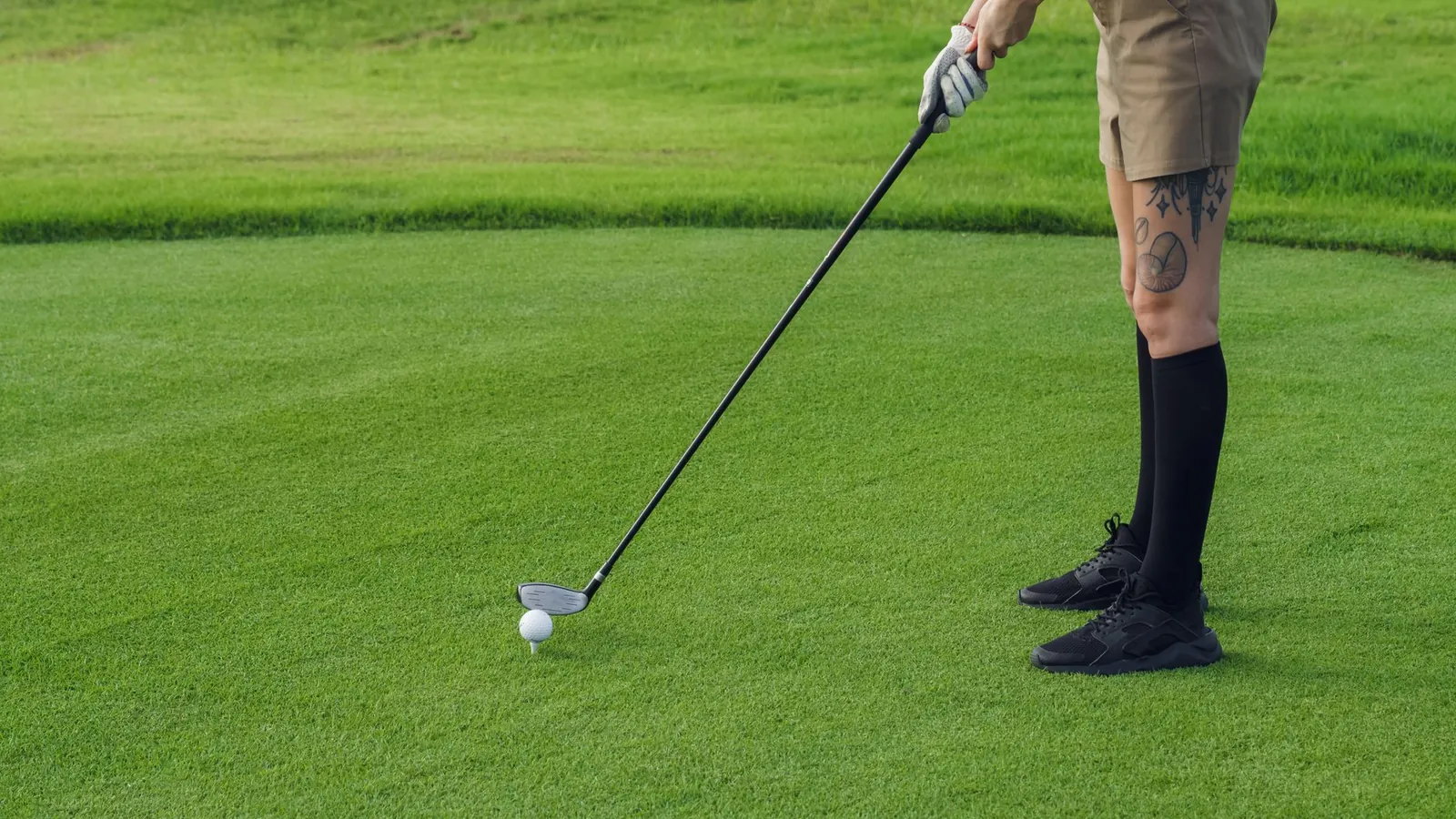 A golfer addressing the ball on a fairway
