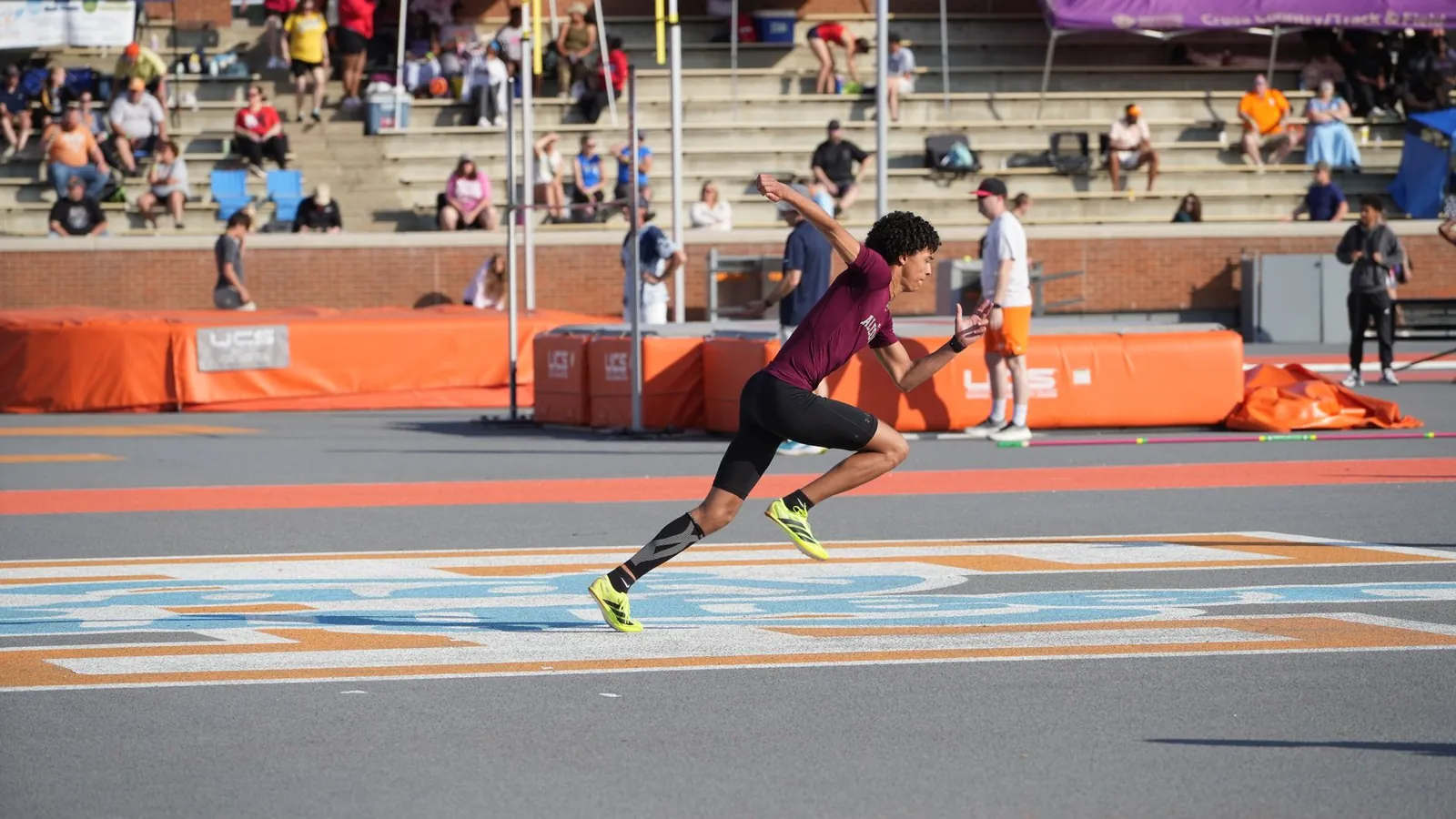 An athlete sprinting at full speed on a track
