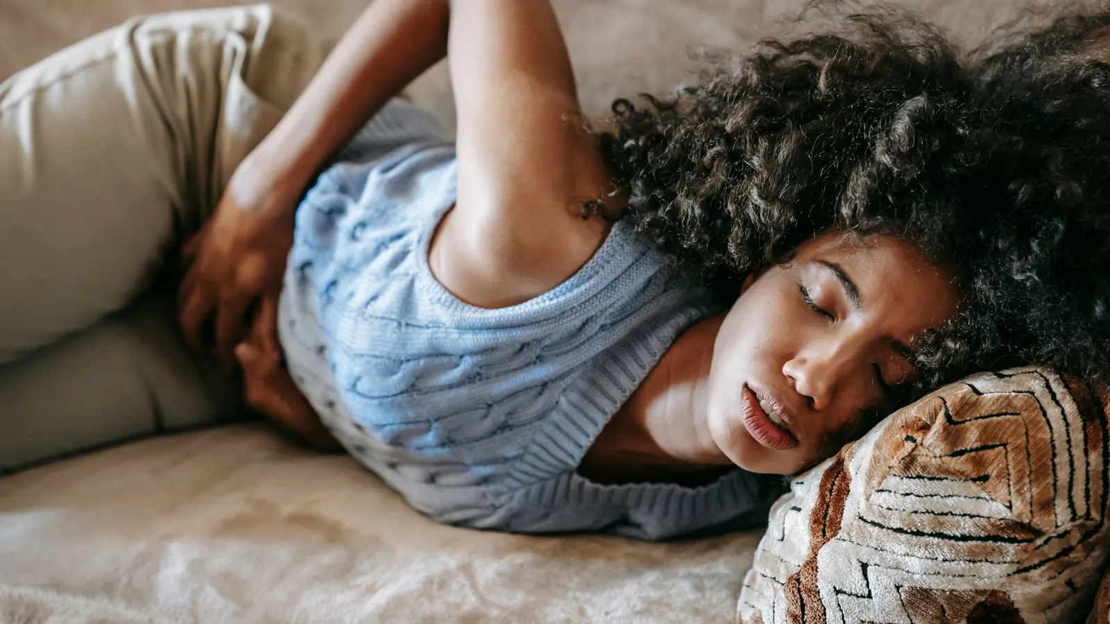 A woman asleep on her side with a hand resting at her hip