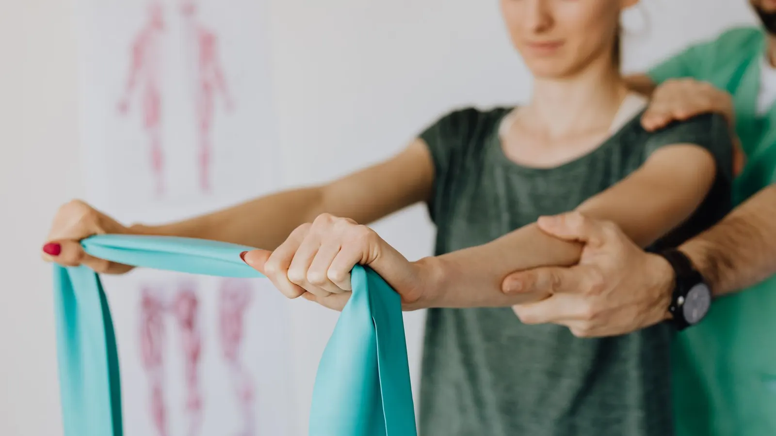 A physiotherapist guiding a patient through a resistance band exercise