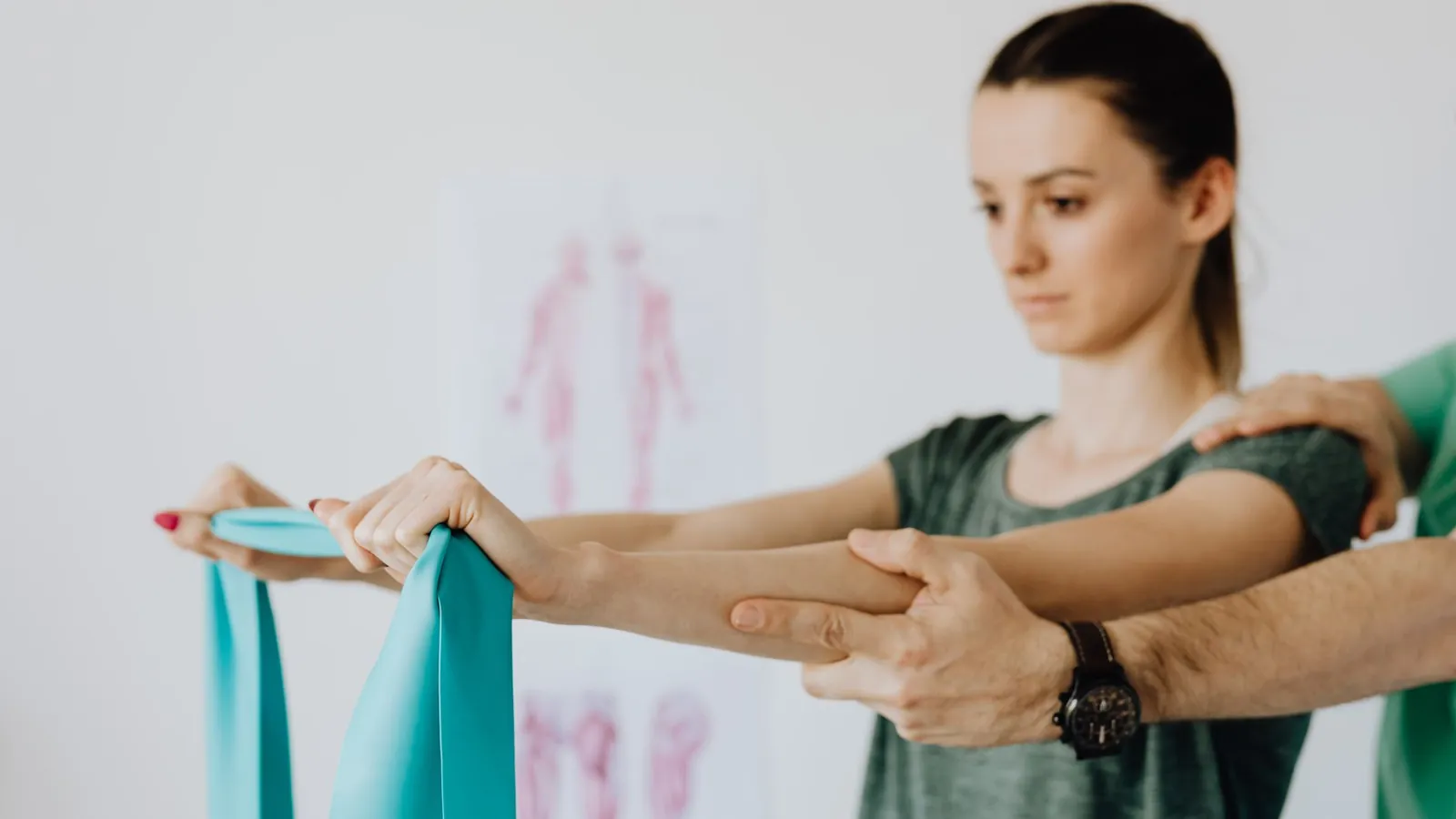 A patient exercising with a resistance band guided by a physiotherapist