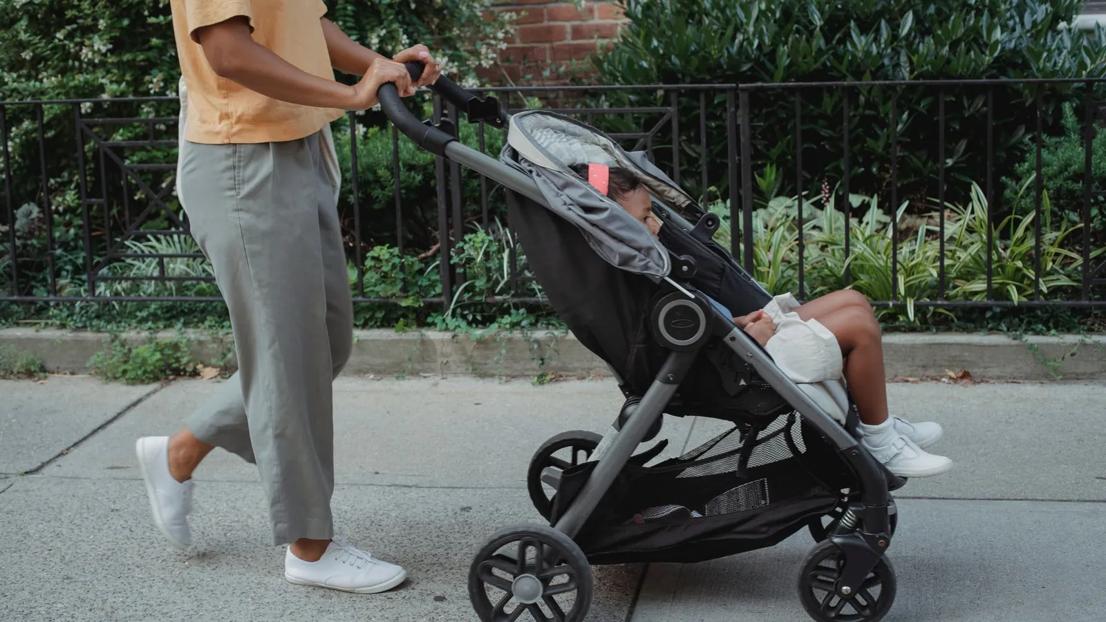 A parent walking briskly while pushing a stroller