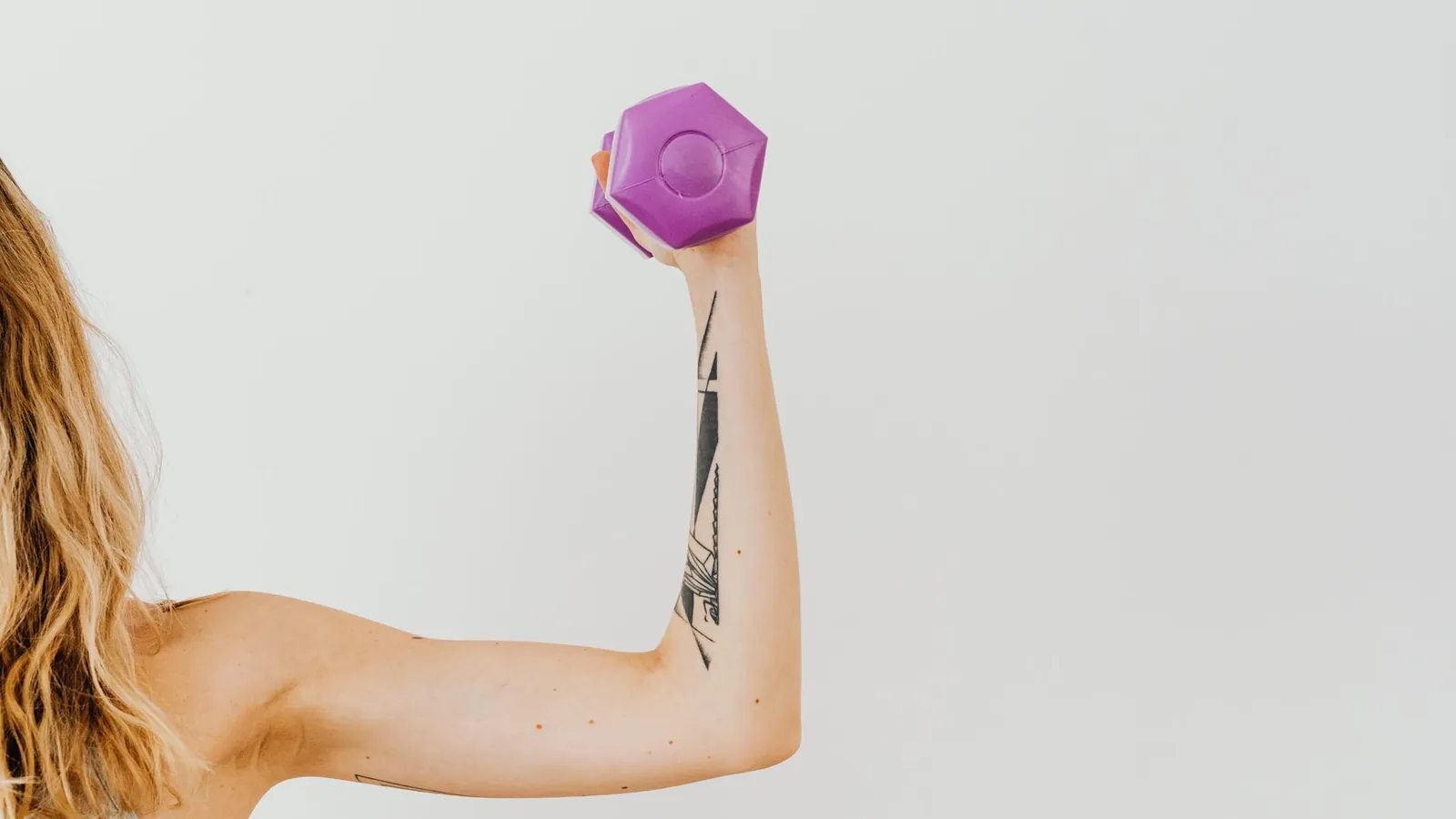An arm raising a small dumbbell