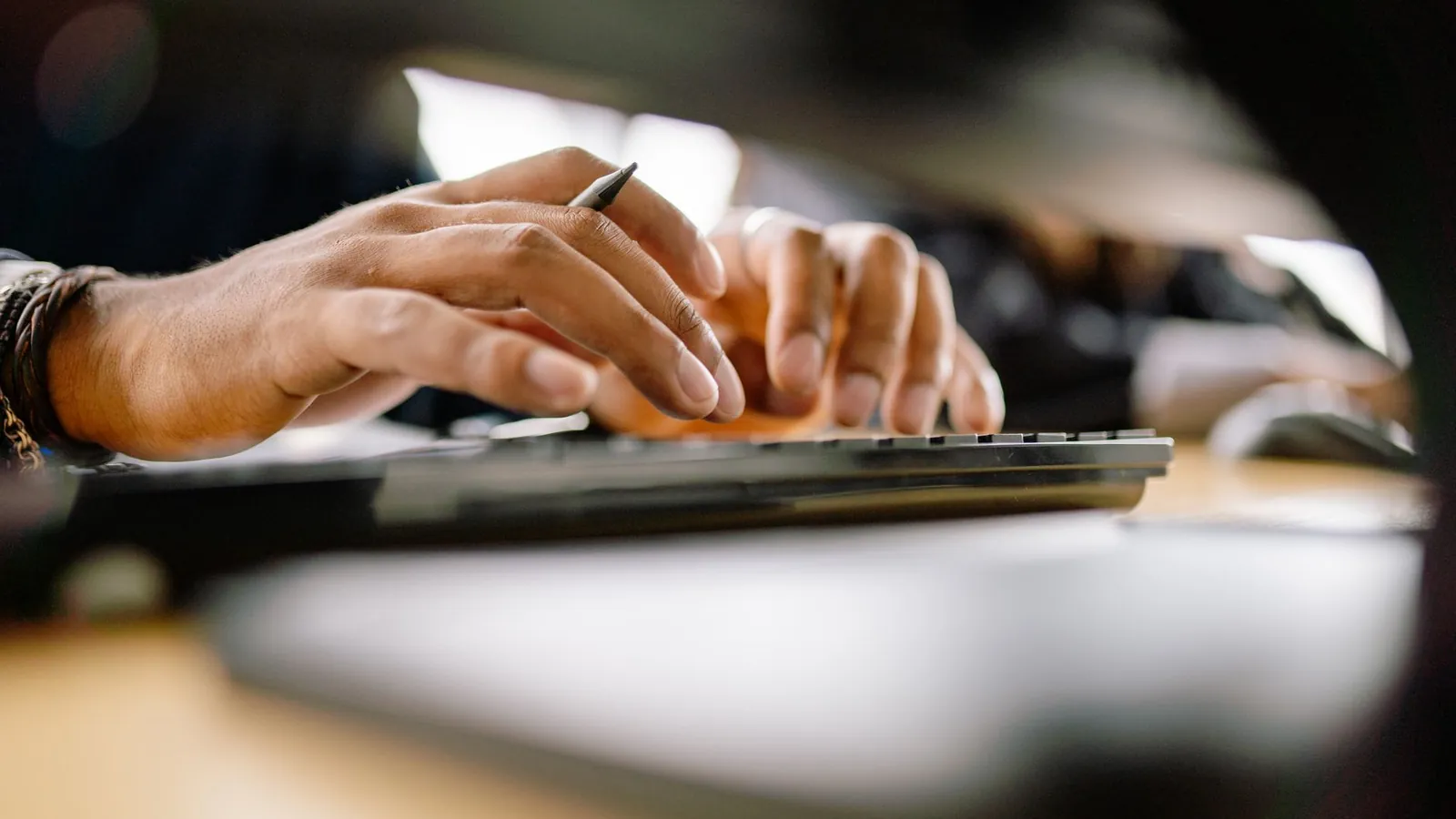 Hands typing on a keyboard
