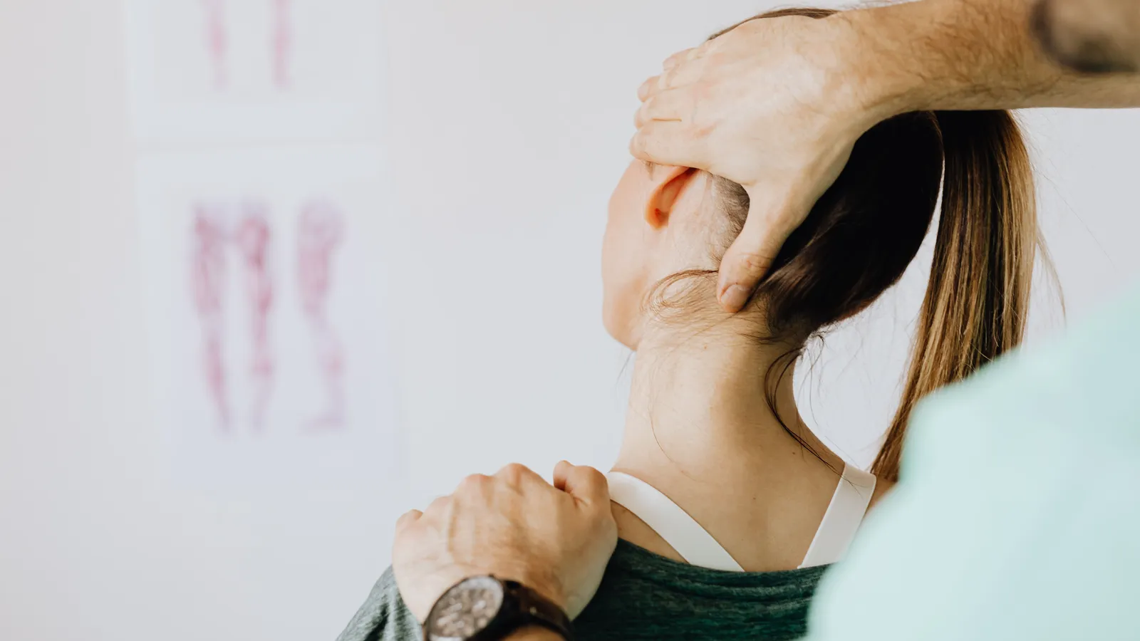 A practitioner guiding a patient's head into a side bend during a neck assessment